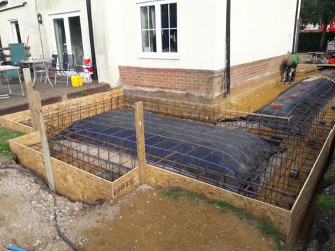 Extension foundations with steel reinforcement laid out ready for the pour