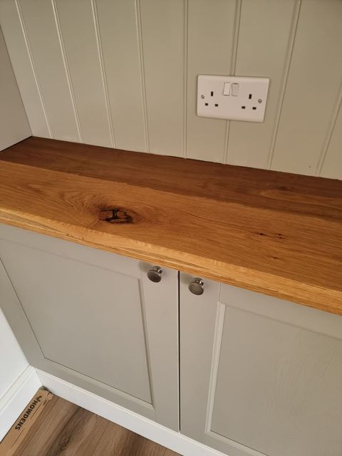 Solid oak worktop on fitted cabinetry, close-up of the grain and finish