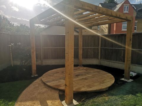 Oak pergola over a circular deck, mid-build