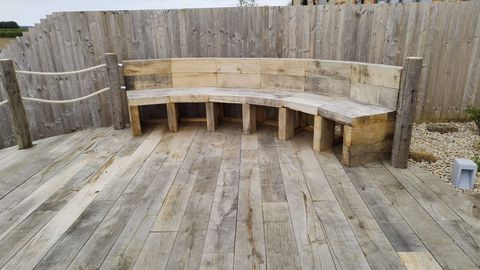 Curved bench built from oak sleepers on a circular timber deck